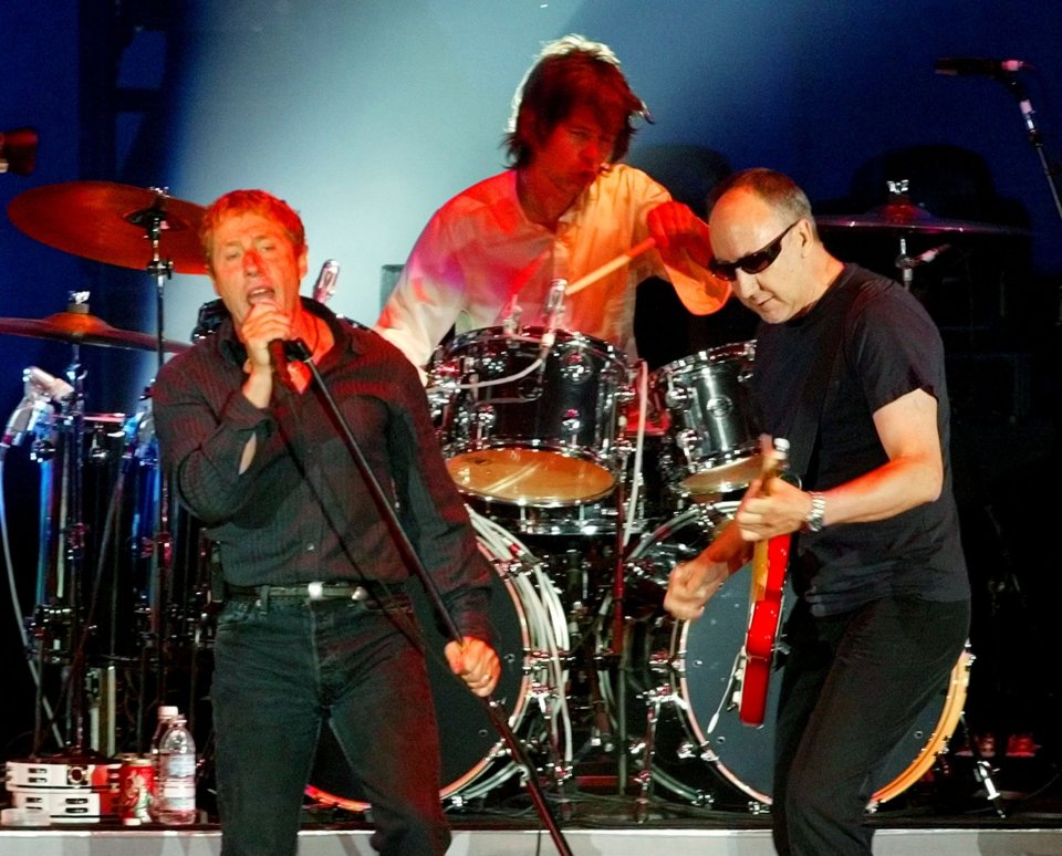 Roger Daltrey, Pete Townshend, and Zak Starkey of The Who performing on stage.