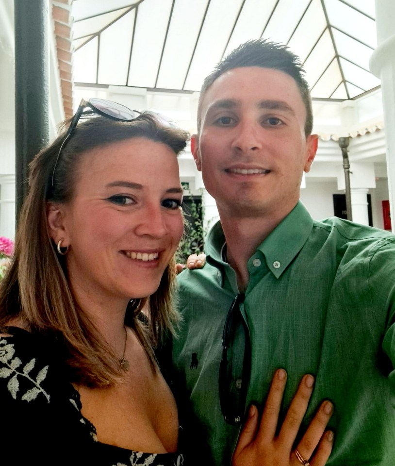 A couple smiling for a selfie.