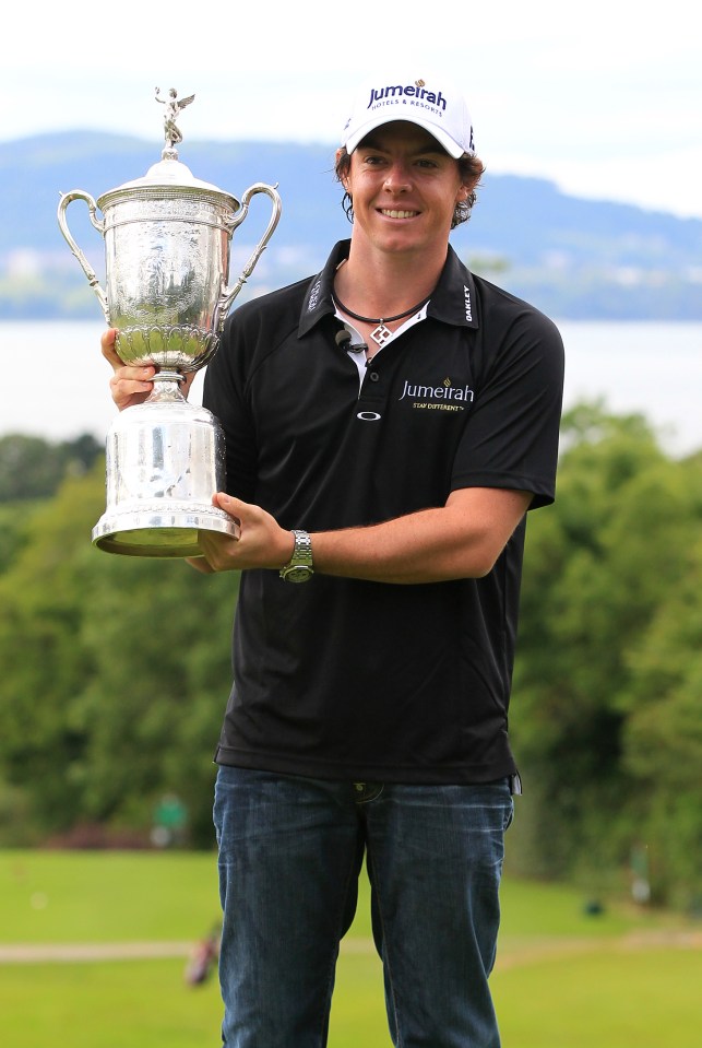 Rory McIlroy holding the US Open trophy.