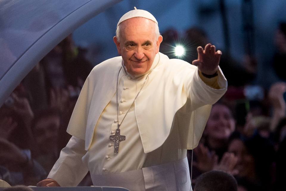 Pope Francis waving to a crowd.