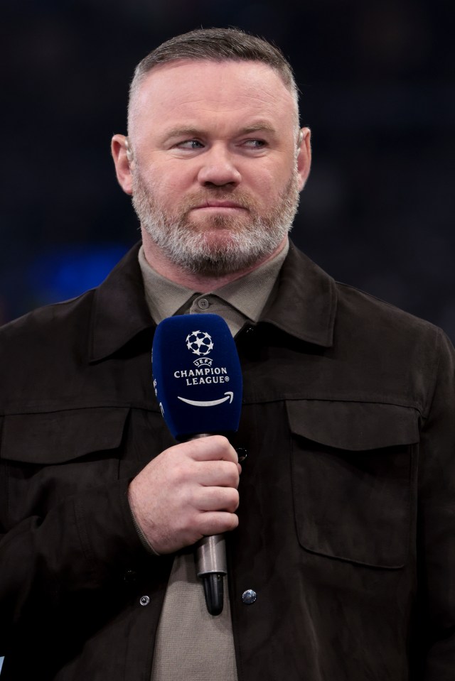 Wayne Rooney holding a UEFA Champions League Amazon Prime microphone.
