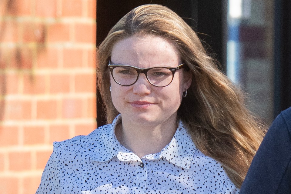 A policewoman in glasses, crying during a court hearing.