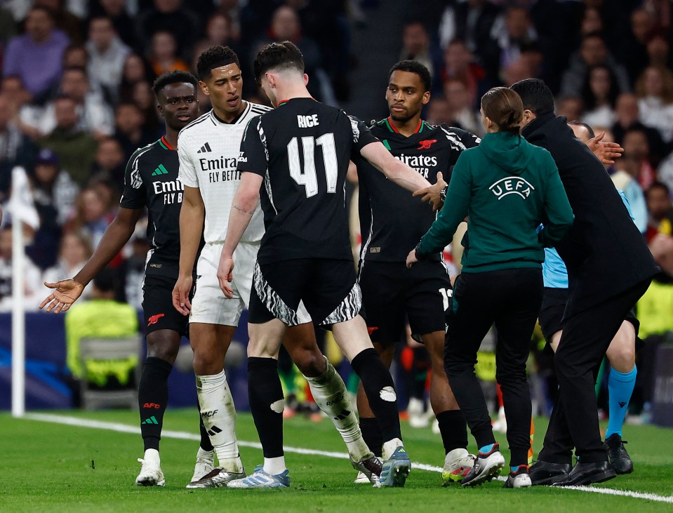 Real Madrid's Jude Bellingham and Arsenal's Declan Rice arguing during a soccer match.