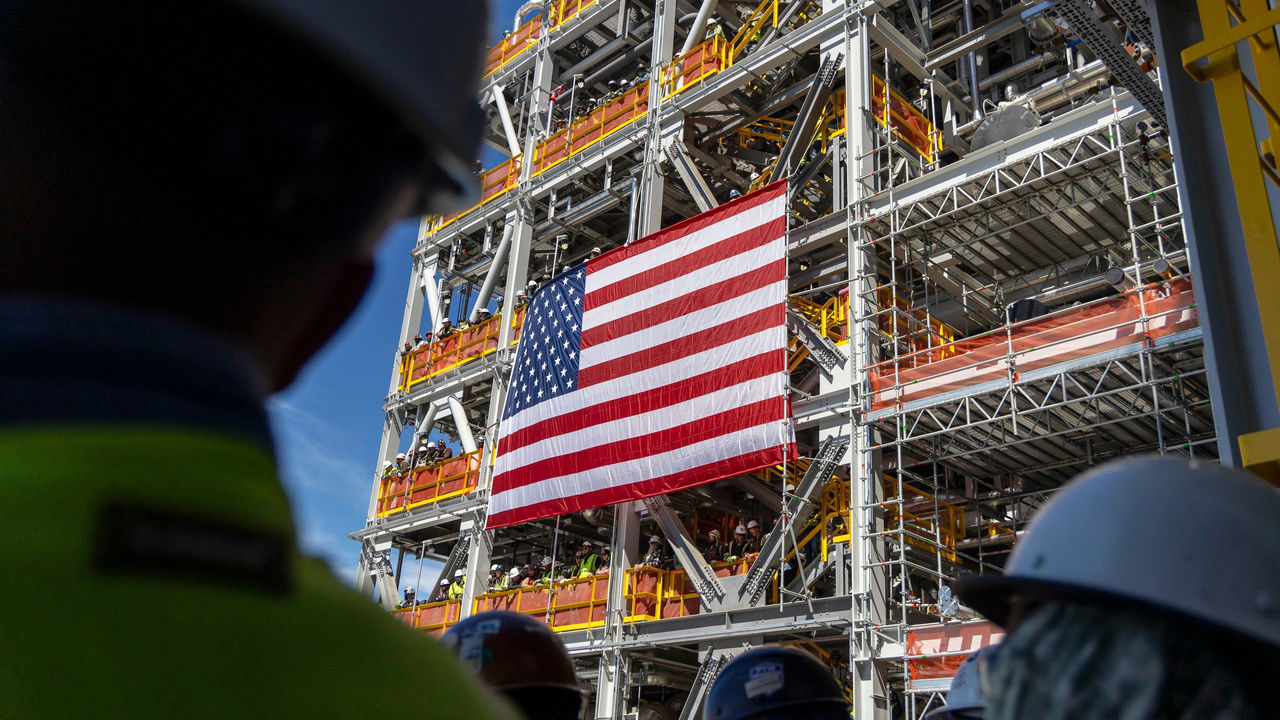 A large US flag hangs on a liquefied natural gas export facility in Port Sulphur, Louisiana, US.