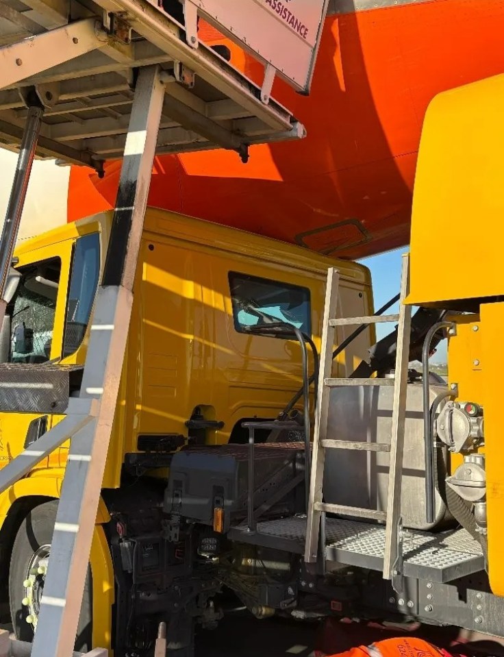 A yellow truck collided with an airplane on an airport tarmac.