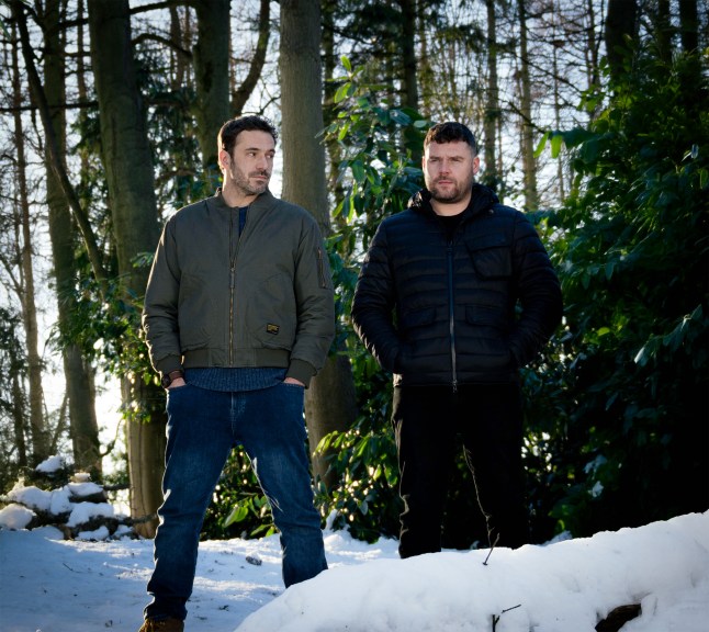 John Sugden and Aaron Dingle standing in the woods in the snow in Emmerdale.