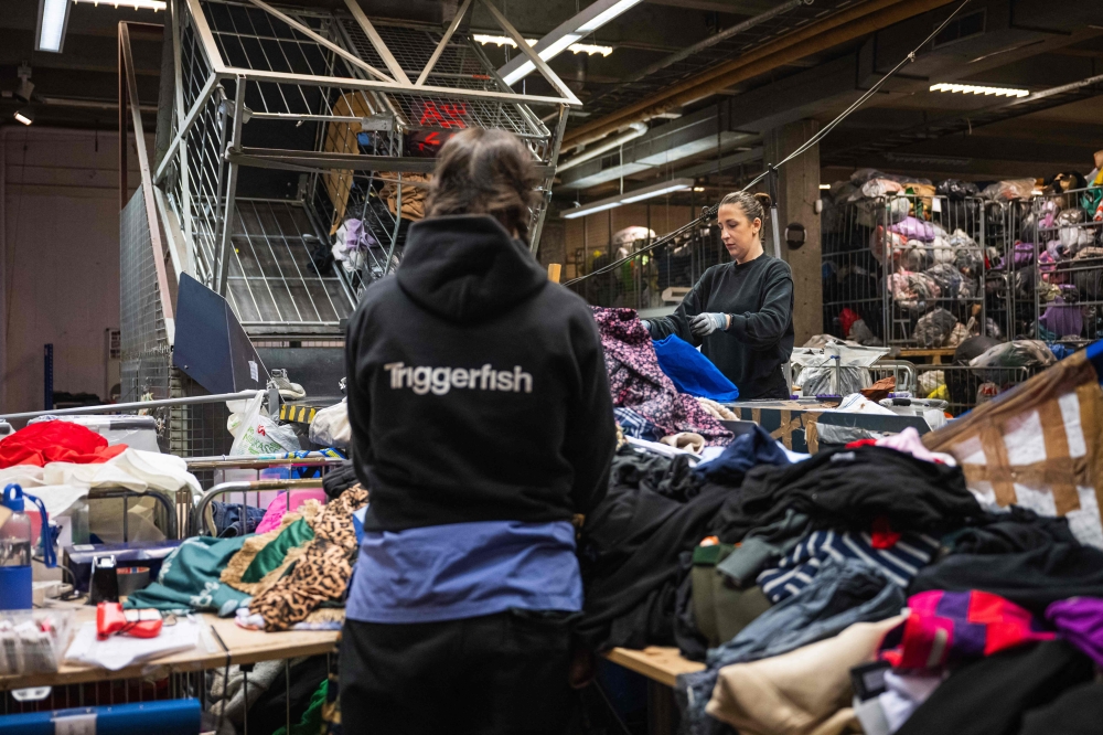 Workers sort incoming items at Artikel2’s sorting centre in Stockholm April 10, 2025. — AFP pic