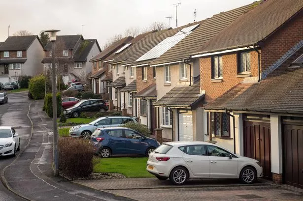 Edinburgh, UK - February 20, 2016: Cars parked on the street and driveways outside terraced houses in north Edinburgh, Scotland.