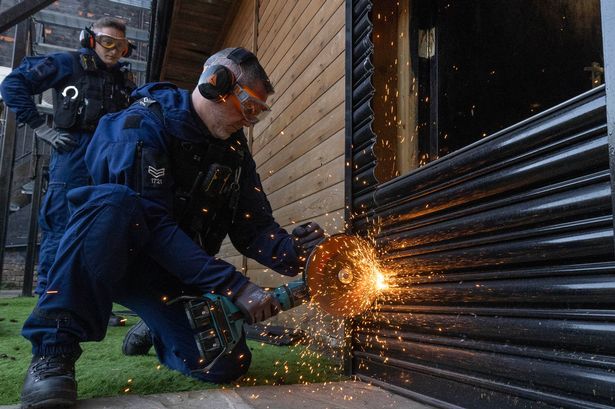 Greater Manchester Police carry out a warrant on a property following an MEN investigation