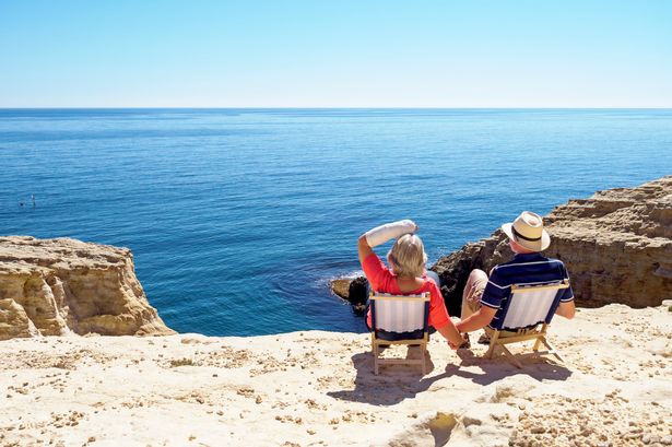 Two people sitting on deck chairs