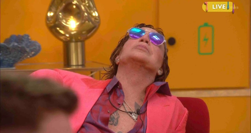 Mickey Rourke in a pink jacket and sunglasses.