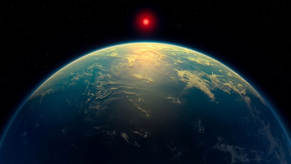 An illustration depicts a Hycean world, or an exoplanet with a liquid water ocean beneath a hydrogen-rich atmosphere, orbiting a red dwarf star. - A. Smith, N. Madhusudhan/University of Cambridge/Reuters