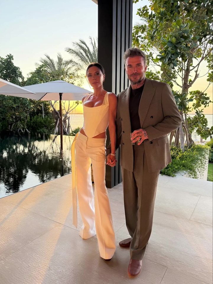 Victoria and David Beckham holding hands at sunset.