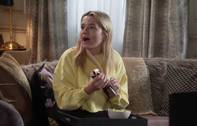 Betsy holding a pepper mill with both hands in Corrie