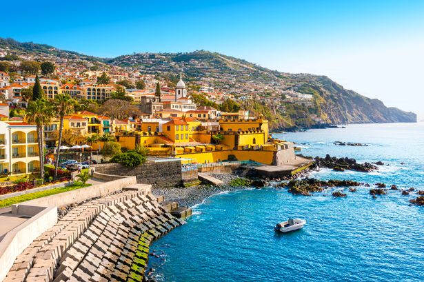 Aeral view of blue clear skies, seaside, mountains and buildings