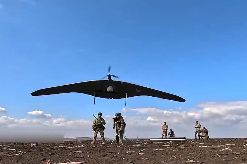 Russian soldiers launch a Supercam intelligence unmanned aerial vehicle in Ukraine. (Russian defence ministry Press Service via AP)