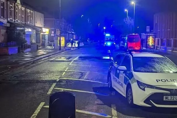 Police are pictured at the scene in Salford