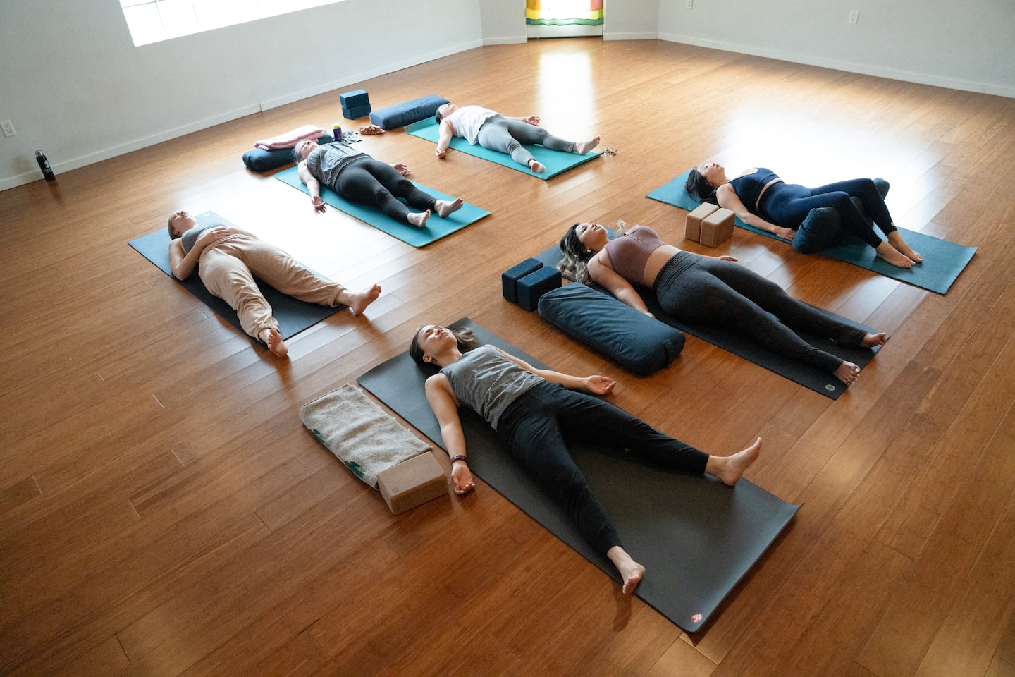 Workers affected by the federal layoffs practice yoga at Bluebird Yoga in Washington, D.C., on March 14.