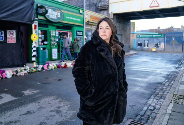 Stacey Slater stands alone in an empty market in EastEnders