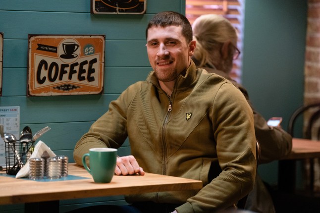 Harry Mitchell looks pleased with himself in EastEnders