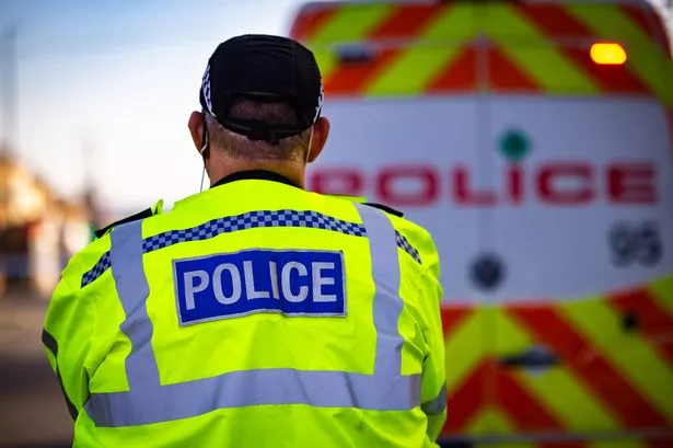 A generic image of a police officer and police van