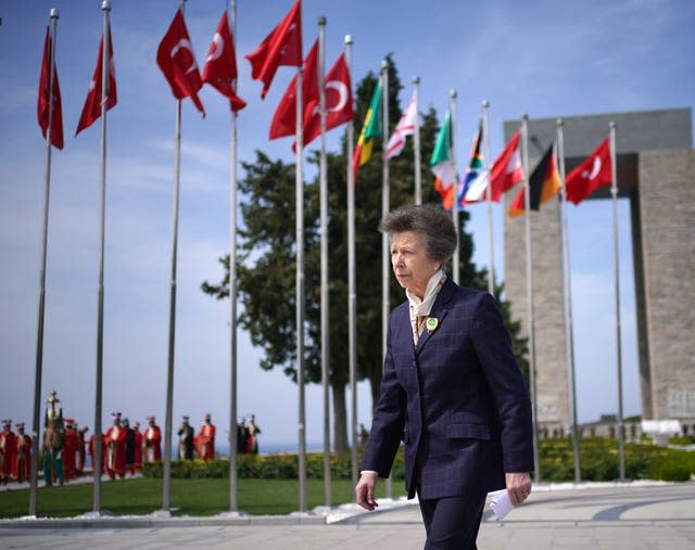 The Princess Royal walks past flags