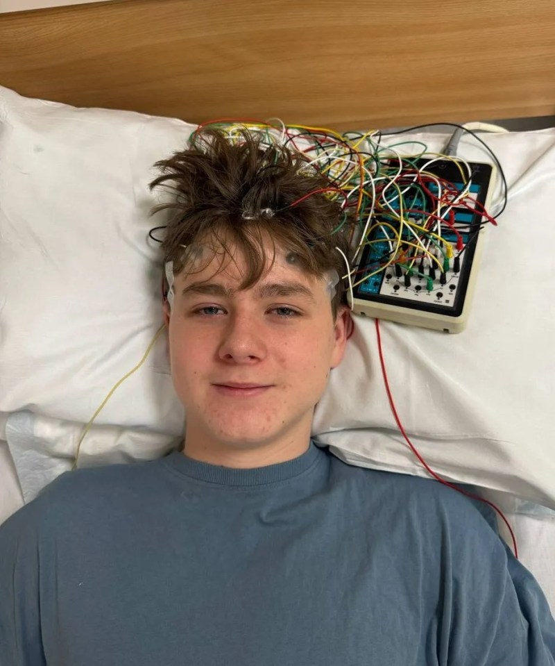 Teenager in a hospital bed undergoing an EEG.
