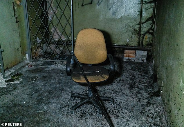 Plastic ties for torture and a broken chair are seen inside a basement of an office building, where prosecutors say 30 people were held two months during a Russian occupation, amid Russia's attack on Ukraine, in Kherson