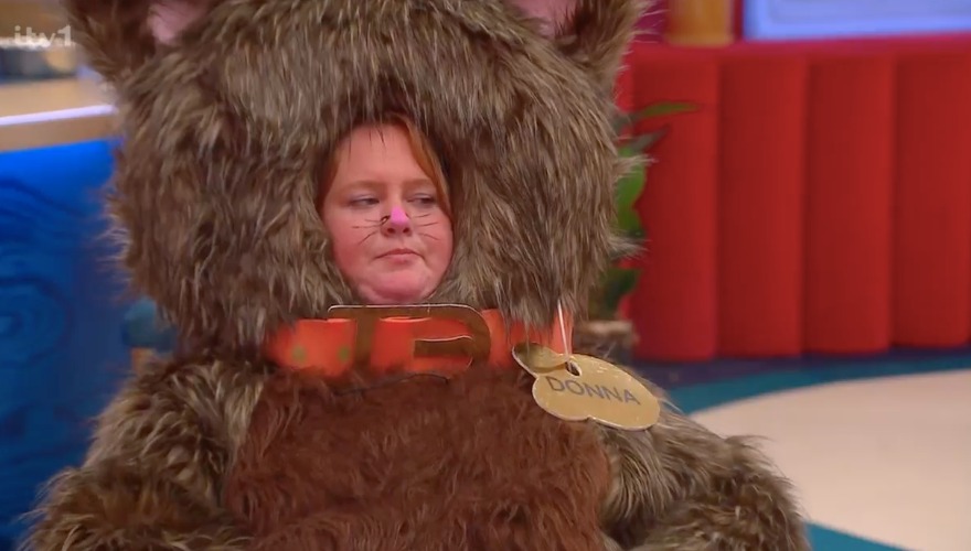 Woman in a brown furry cat costume with a name tag that says Donna.