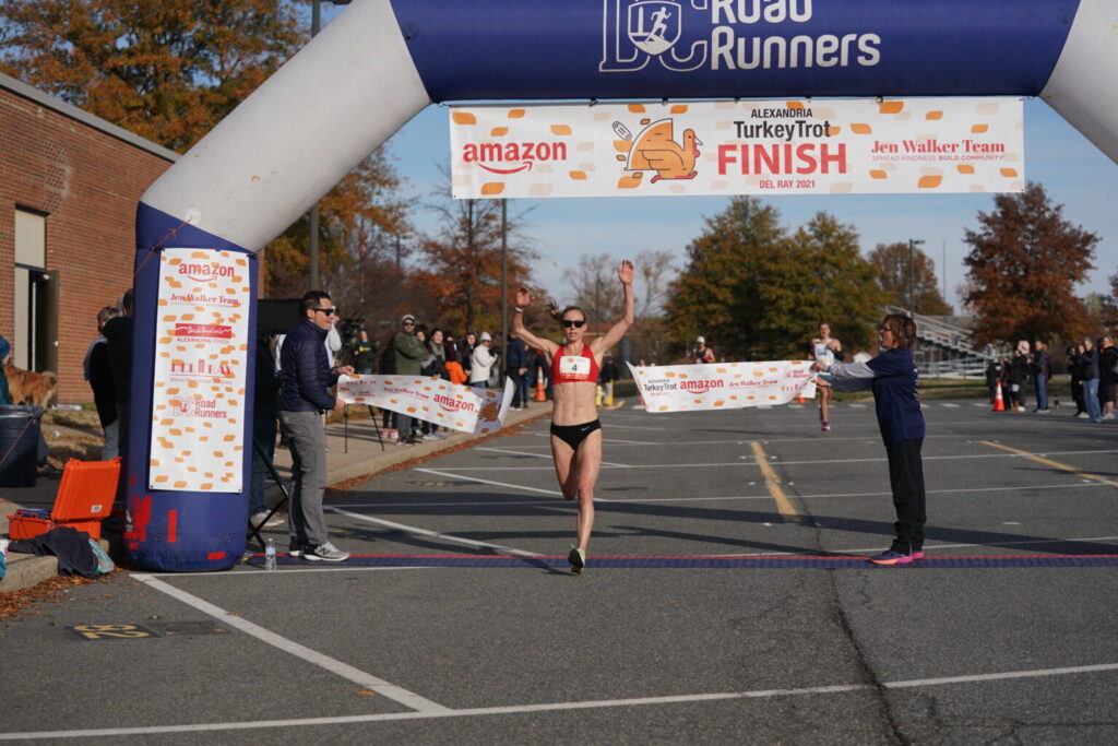 Susanna Sullivan crosses the finish line at the Turkey Trot.