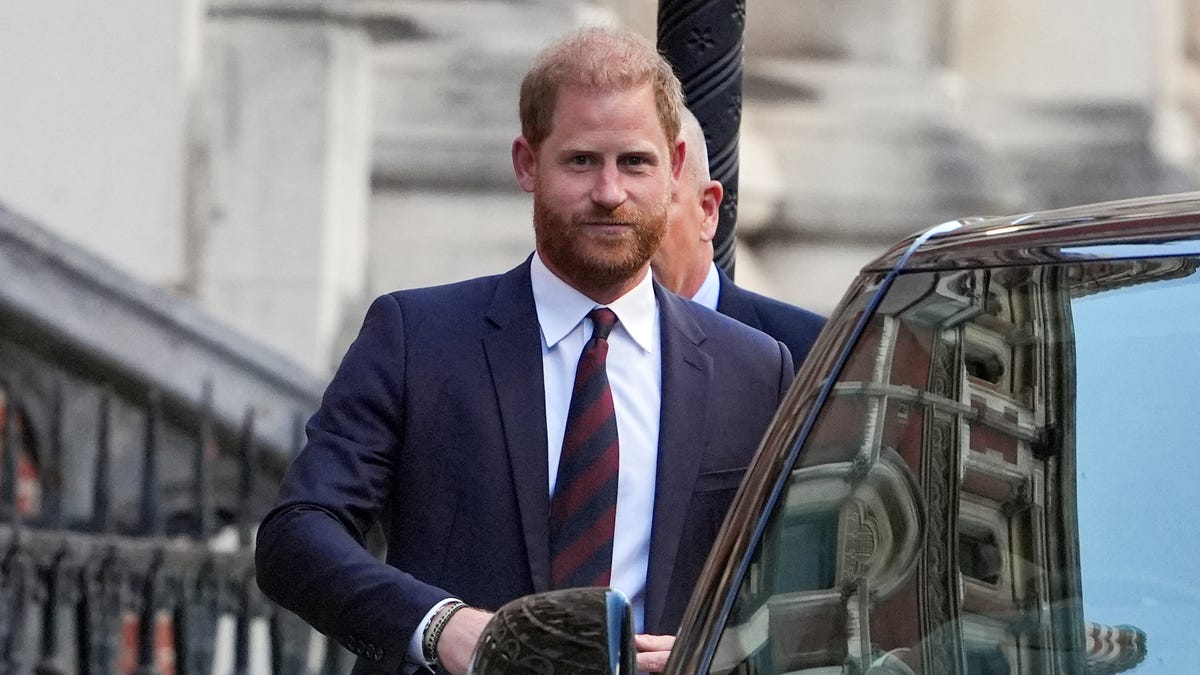 Prince Harry rushed out of UK court after fan outburst