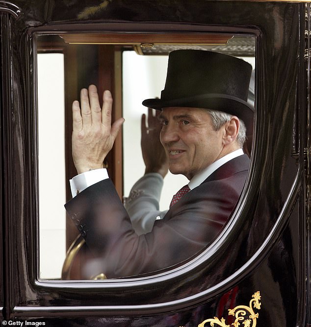 Michael waving to well-wishers as he travelled in a carriage to Buckingham Palace after the wedding ceremony