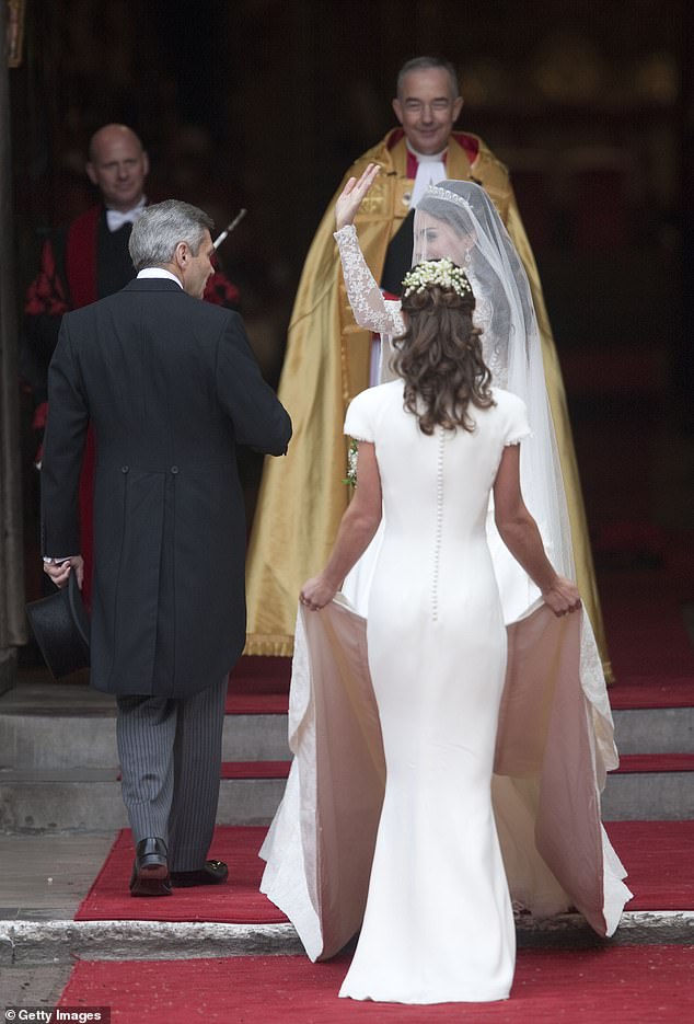 Pippa holding Kate's train as Kate and Michael walk into the Abbey