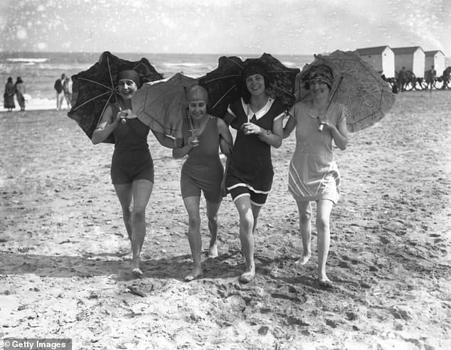 Bathers are captured using parasols to shade themselves from the sun at Skegness beach in 1926. Cotswold Outdoor explains: 'One of the most striking features of Skegness Beach is its expansive stretch of soft, golden sand'