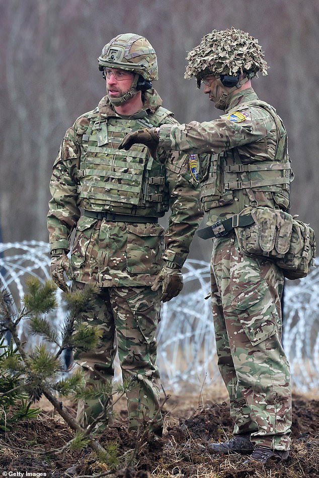 The Prince of Wales speaks with a soldier during some field training after the official handover ceremony between The Royal Dragoon Guards and the Mercian Regiment