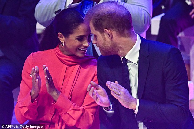 As Meghan expressed her delight in having Harry by her side, she accompanied her words with long blinks, coy expressions and playful giggles