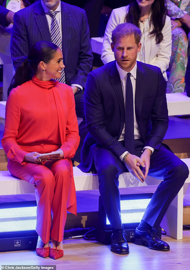 Harry and Meghan sat centre stage on a bench together as they joined One Young World counsellors to watch the flag bearers enthusiastically parading the flags of more than 200 countries during the opening ceremony