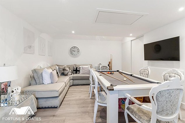 One room even has white chairs neatly tucked in around a white pool table, with a few grey and black appliances scattered throughout the home the only differing colour