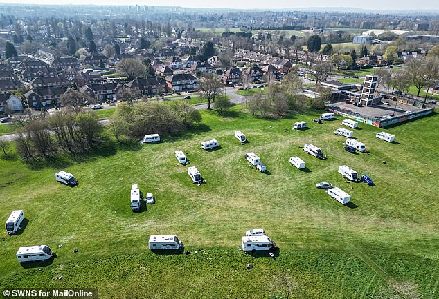Dozens of vehicles and trailers were also parked up on playing fields at Swanshurst Park, in Birmingham on April 3 (pictured)