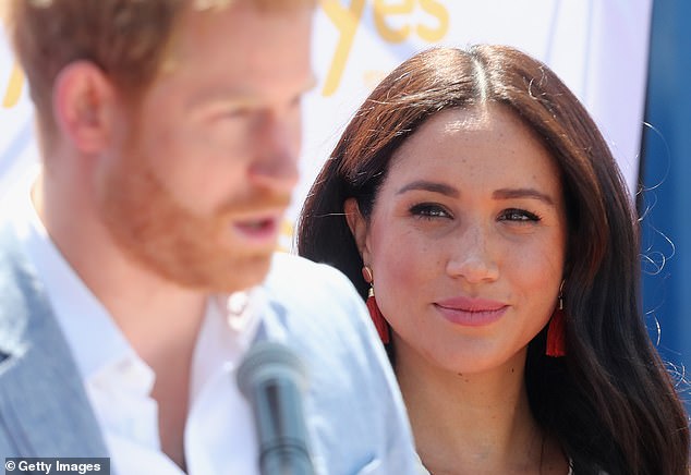 Meghan watched her husband, Prince Harry speaking during a visit to a township to learn about Youth Employment Services in Johannesburg, South Africa