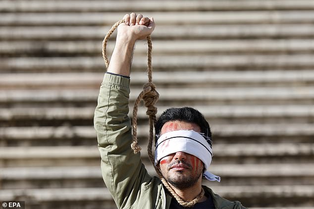 A man protests against executions in Iran in December 2022