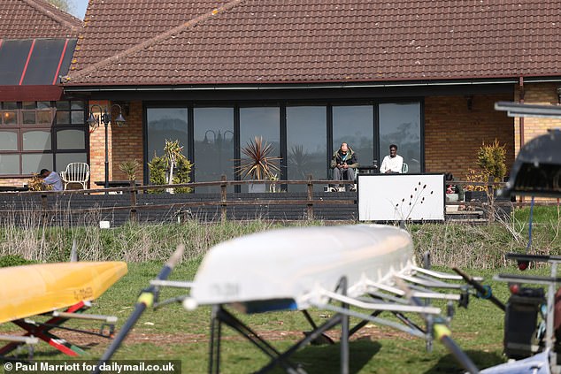 People are seen outside The Dragonfly Hotel which is now being used to house asylum seekers