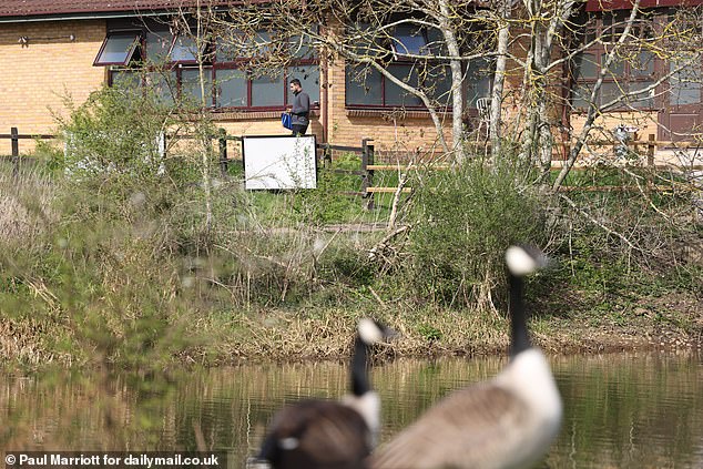 People are seen outside of The Dragonfly Hotel which is now being used to house asylum seekers