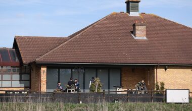 People are seen outside The Dragonfly Hotel in Thorpe Meadows, Peterborough, which is now being used to house asylum seekers