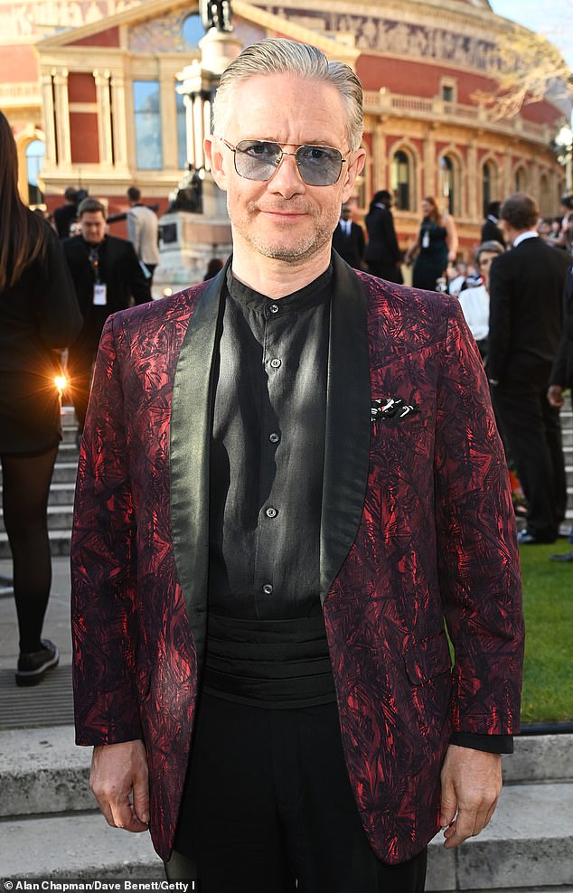 For the outing Martin sported a quirky red and black blazer which he paired with black trousers. He finished his unique ensemble with a pair of slip-on leather suit shoes