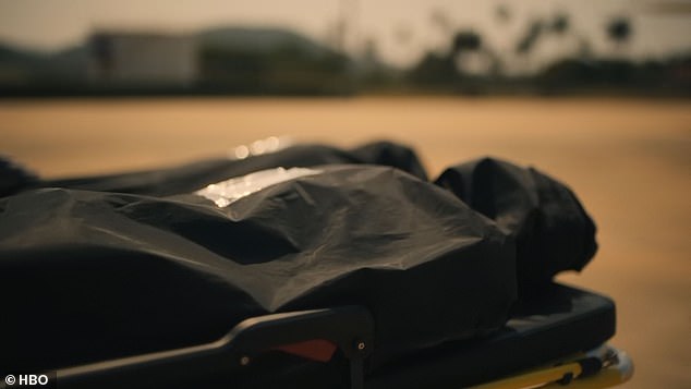 Two corpses are being rolled towards a waiting airplane