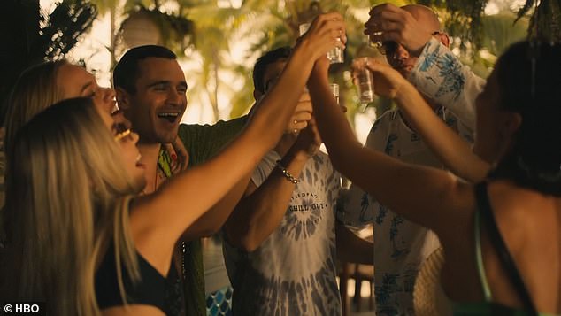 Valentin and his criminal friends celebrate with shots as Frank prays in a temple