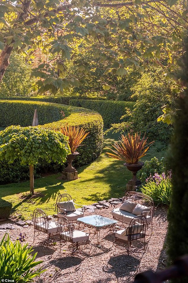 The estate is a masterclass in garden design: over 300 deciduous trees, towering hedges, orchard groves, perennial borders, a vegetable garden, and sculptural elements
