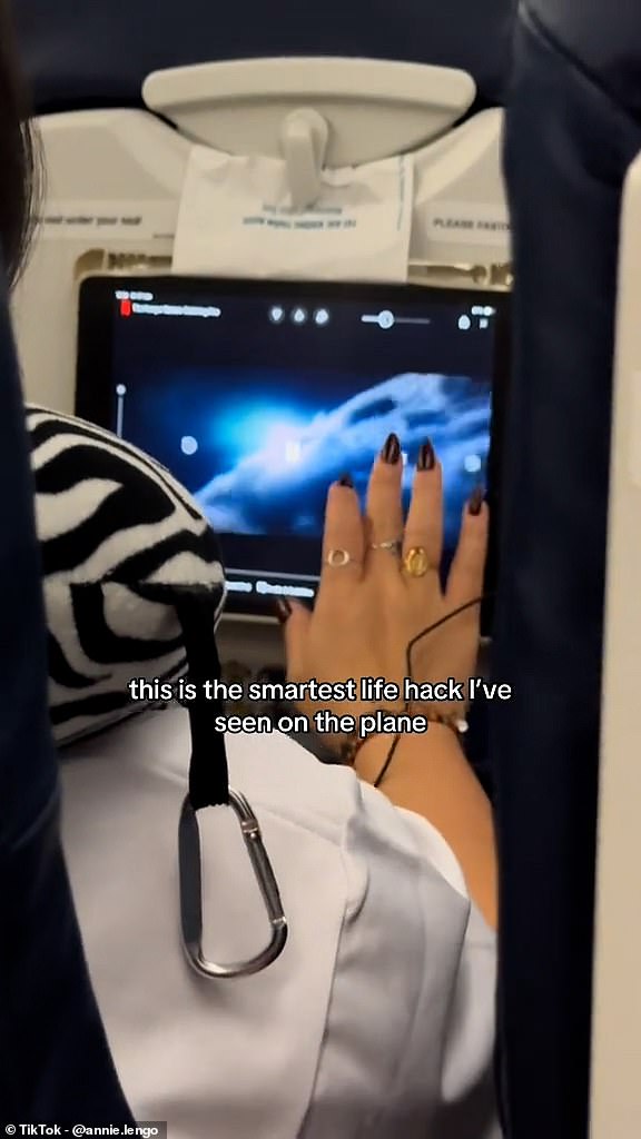 Annie Lengo discovered a fellow plane passenger had used a sick bag to 'hang' her iPad to the tray table latch, keeping it in a stable position for hands-free viewing