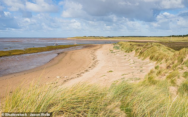 Hightown beach backed by sand dunes leading to the top of the River Alt near Liverpool